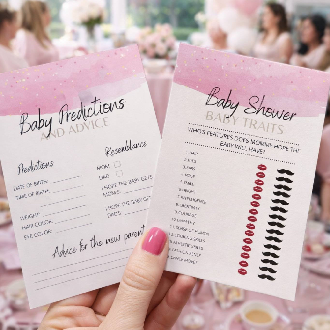 Hand holding baby shower game cards with pink and white design, blurred background of a party.